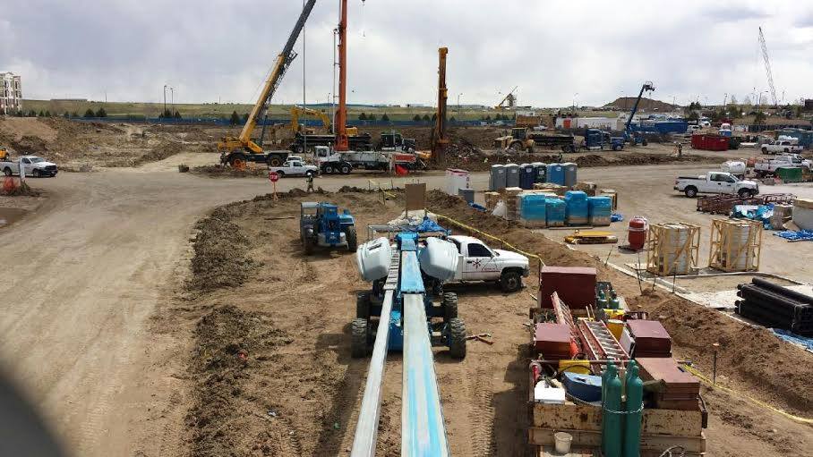 Heavy equipment and construction materials on a construction site.