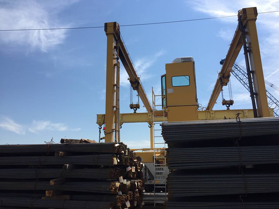 A pile of steel bar and heavy equipment.