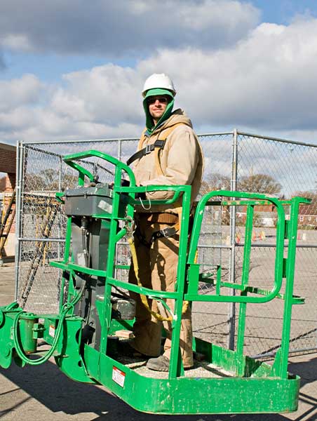 Construction worker standing on a Articulated Boom Lifts platform.