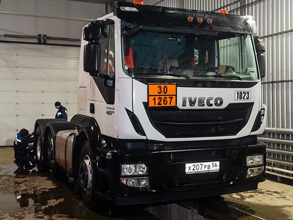 Truck technician Fixing a truck in a repair warehouse.