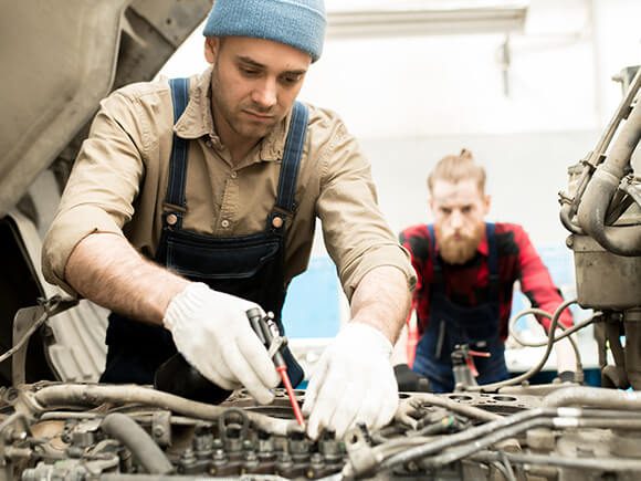 Truck Technician working on a bucket truck engine.