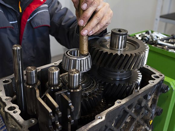 Truck Technician doing maintenance on truck oil pump.