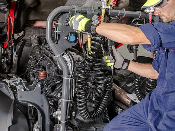 A truck Technician fixes the hydraulics and electrical problems of a dump truck.