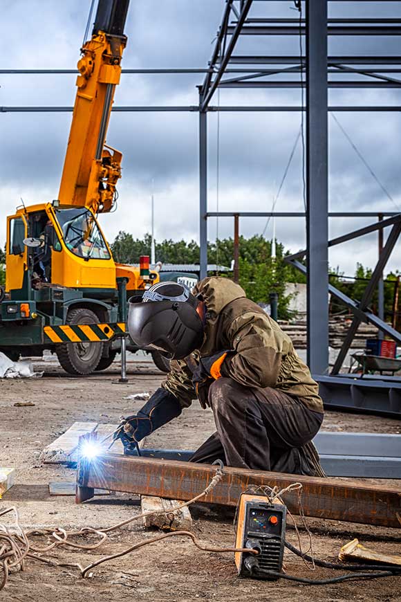 A construction worker using a welding machine.