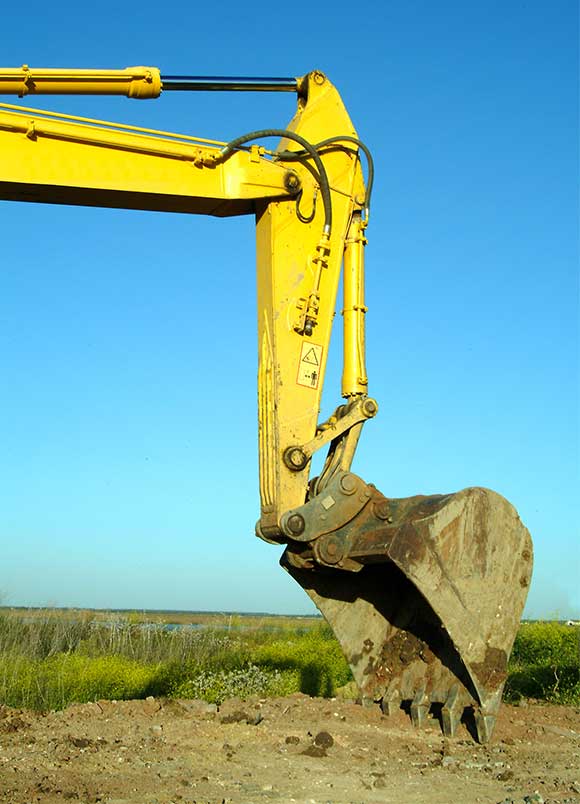 Close-up of an excavator stick and bucket.