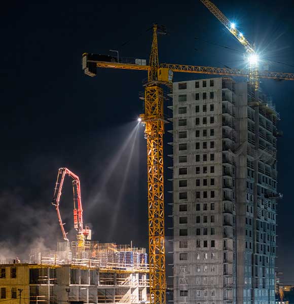 EMT Tower crane at a construction site at night