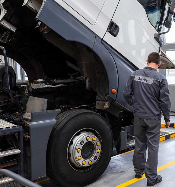 Truck technician doing diagnostics and truck maintenance services.