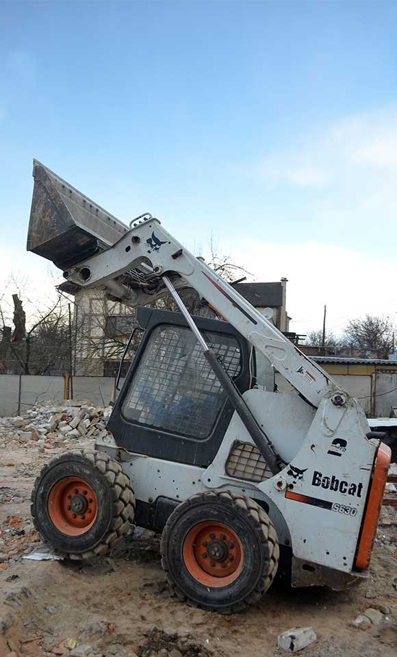 Skid loader on a construction site.