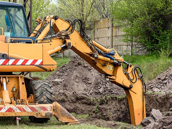 Excavators digging a deep hole.