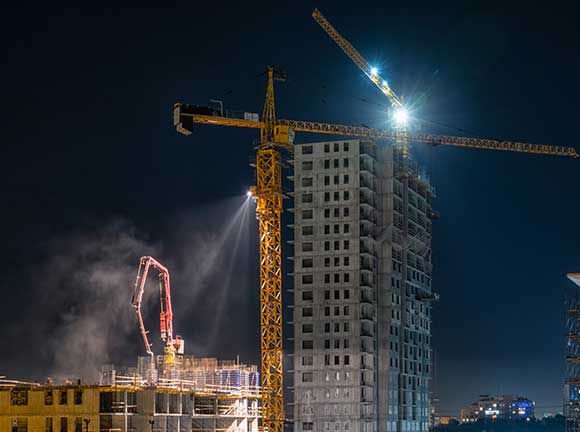 A light tower on crane on a construction time.