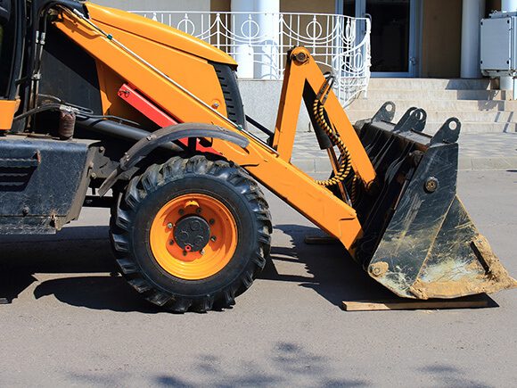 A wheel loader parked on a concrete pavement.