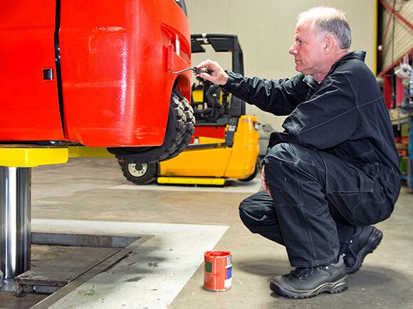 Truck Technician repaints forklift.